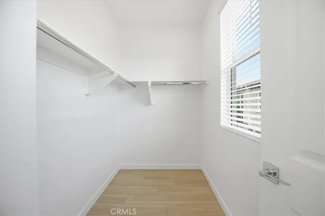 a view of a room with rack on the wall and a window