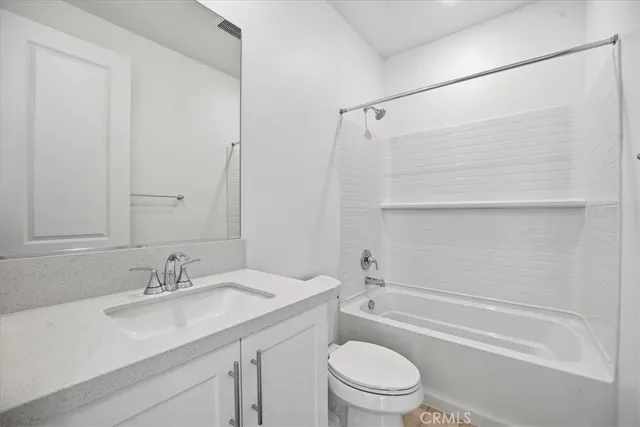 a bedroom with bed and a potted plant