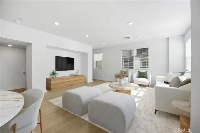 a spacious bedroom with a bed and a flat screen television