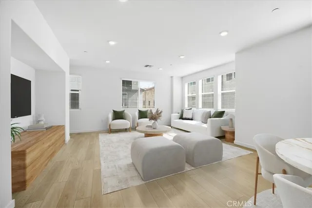 a living room with furniture window and a flat screen tv