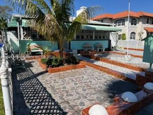 a view of a chairs and table in backyard