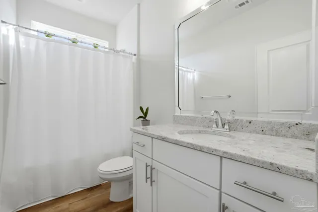 a bedroom with a bed a furniture and a window