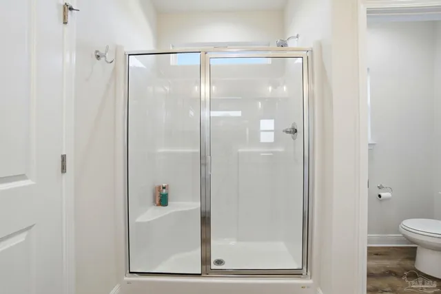 a spacious bathroom with a granite countertop sink a mirror and a bathtub