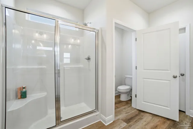 a bathroom with a granite countertop double vanity sink and a mirror