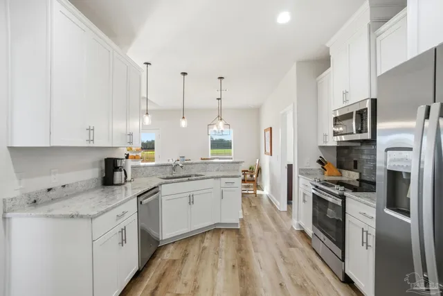 a kitchen with stainless steel appliances a refrigerator stove and microwave