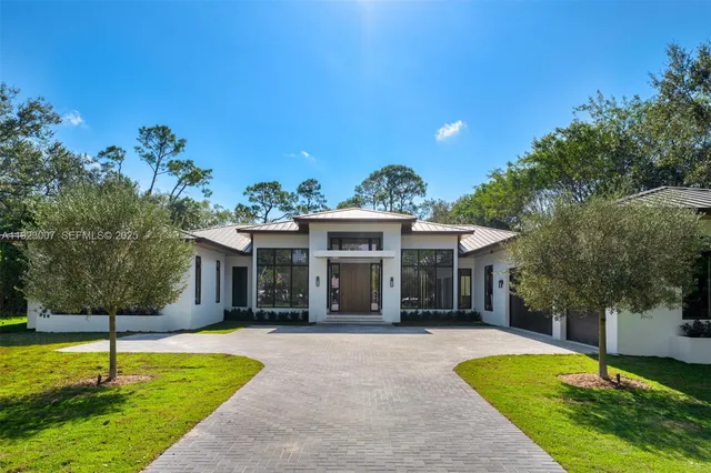 a view of a house with swimming pool and a yard