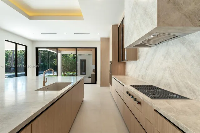 a large white kitchen with a large window