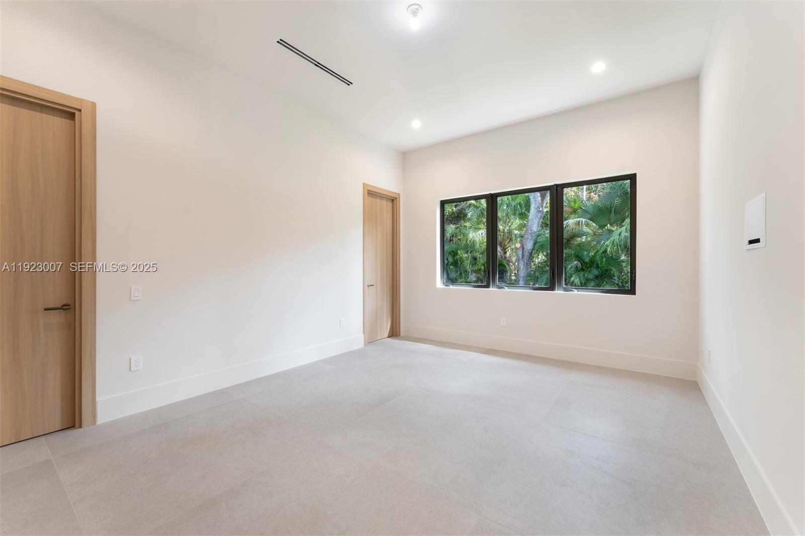 6840 Southwest 92nd Street Pinecrest, FL 33156 - Photo 18 of 42 a view of an empty room with a window