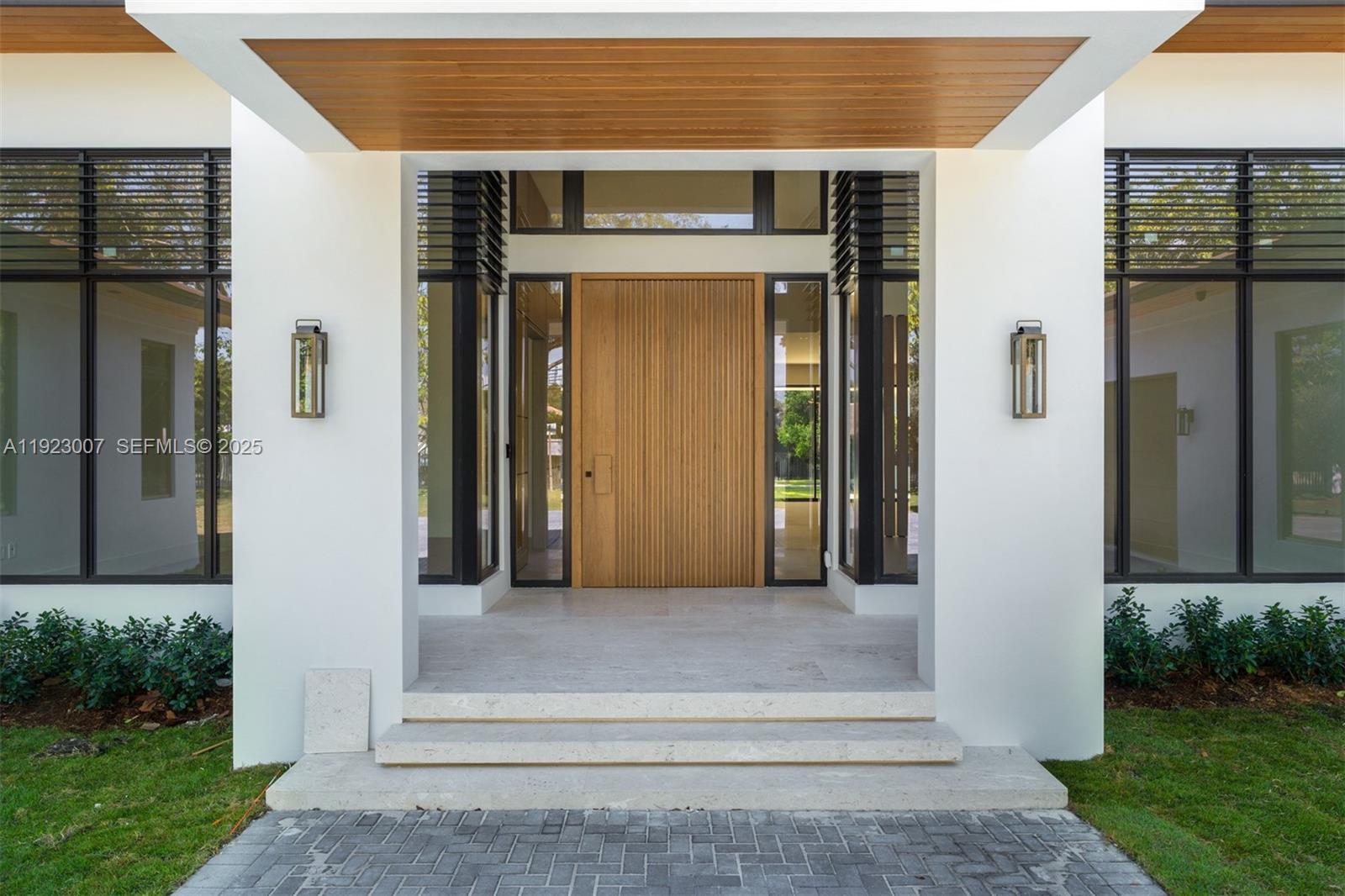 6840 Southwest 92nd Street Pinecrest, FL 33156 - Photo 2 of 42 front view of a house with a yard