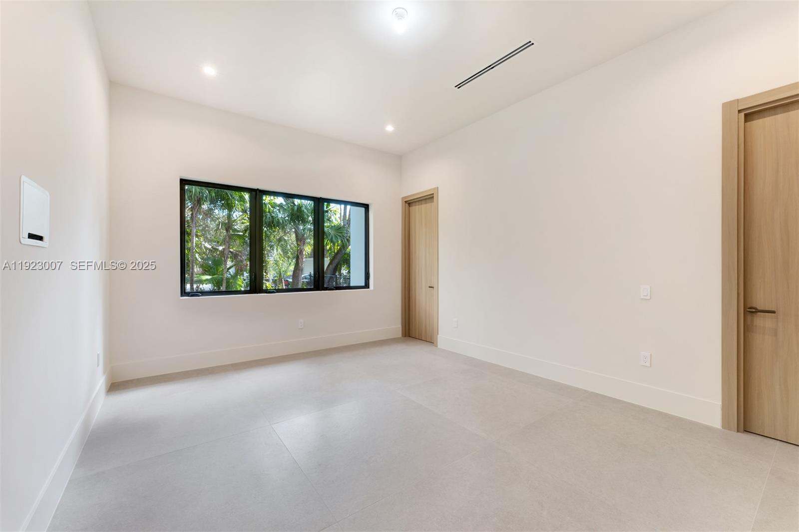 6840 Southwest 92nd Street Pinecrest, FL 33156 - Photo 23 of 42 an empty room with windows