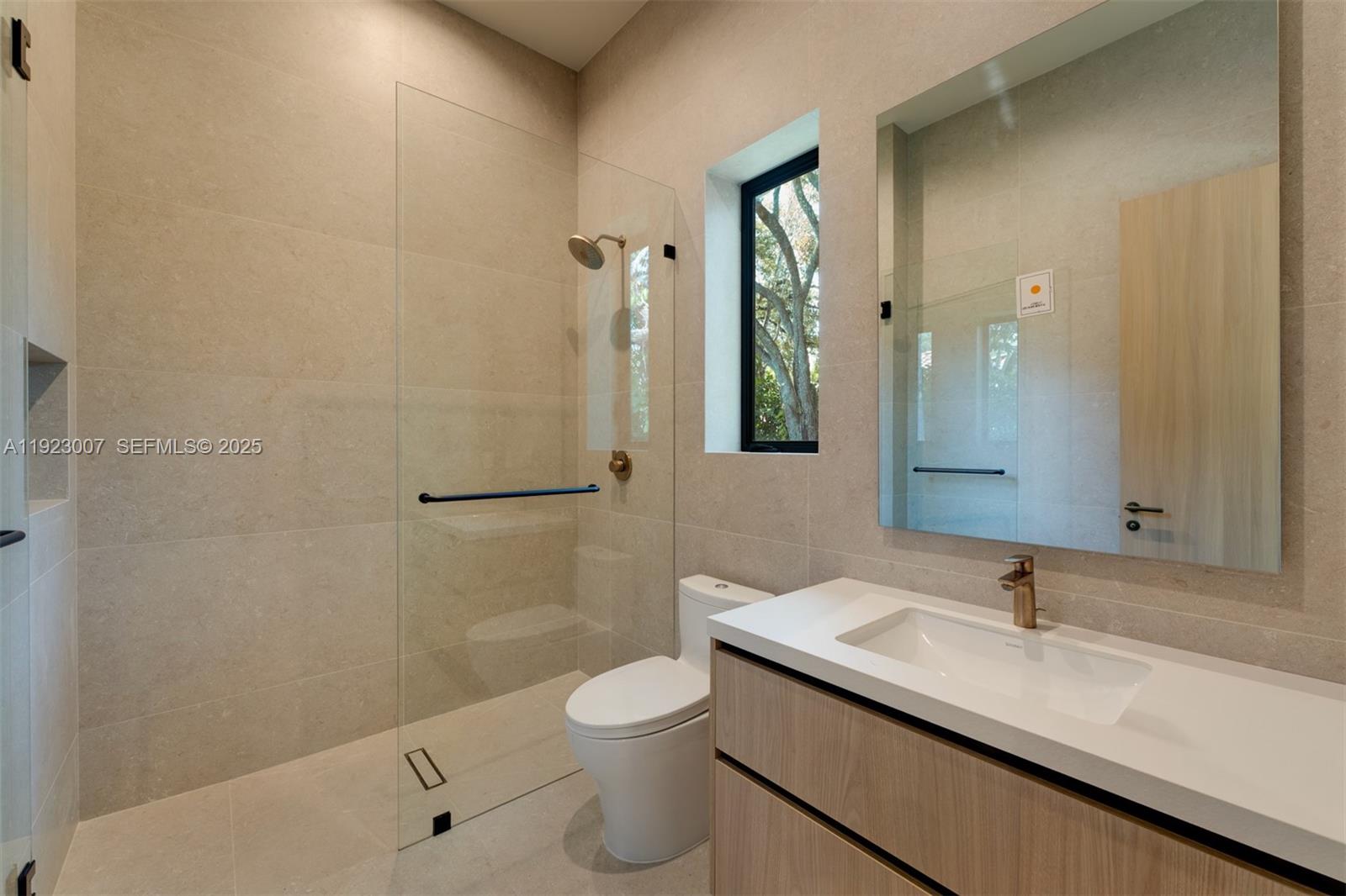 6840 Southwest 92nd Street Pinecrest, FL 33156 - Photo 24 of 42 a bathroom with a sink a toilet and shower