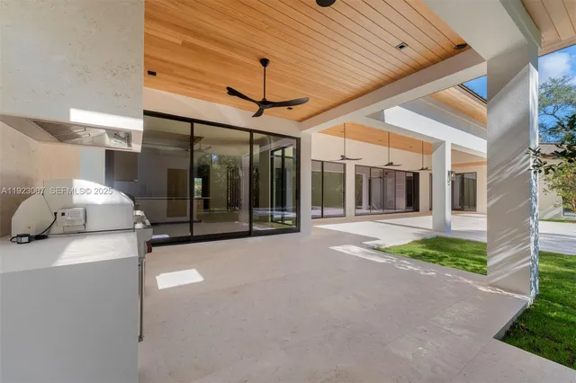 a kitchen with stainless steel appliances a stove and white cabinets