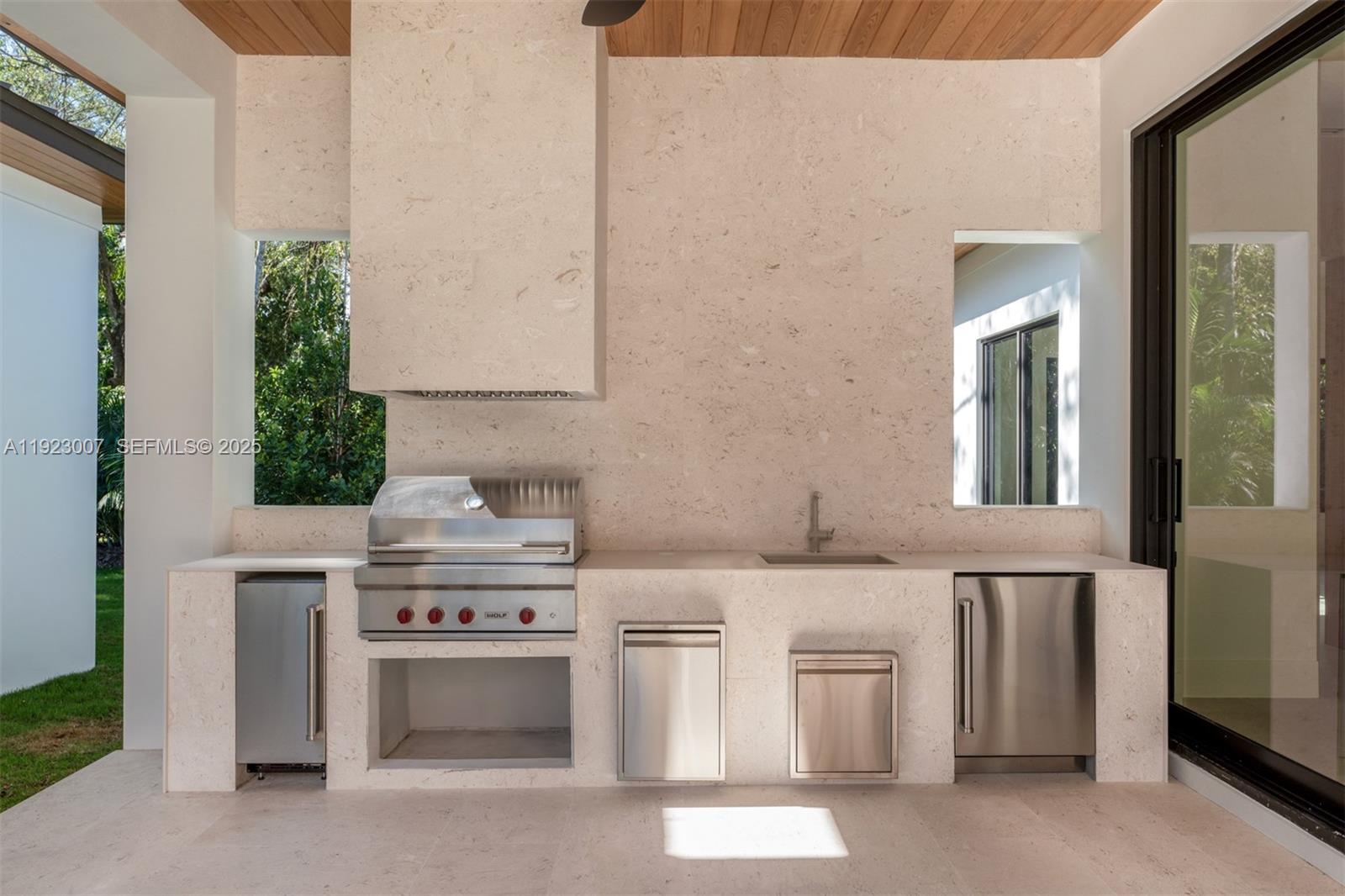 6840 Southwest 92nd Street Pinecrest, FL 33156 - Photo 36 of 42 a kitchen with stainless steel appliances a stove and white cabinets