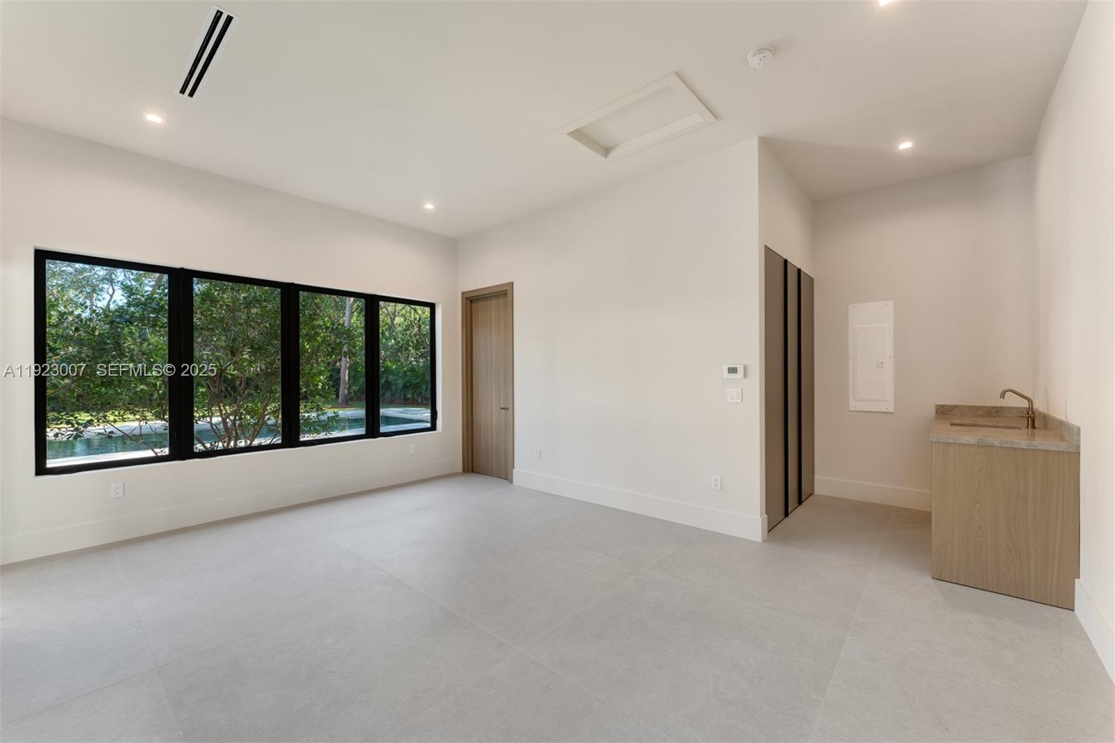 6840 Southwest 92nd Street Pinecrest, FL 33156 - Photo 37 of 42 a view of a big room with windows and chandelier fan