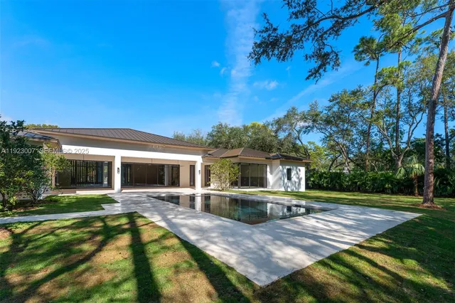 a front view of house with yard and garage