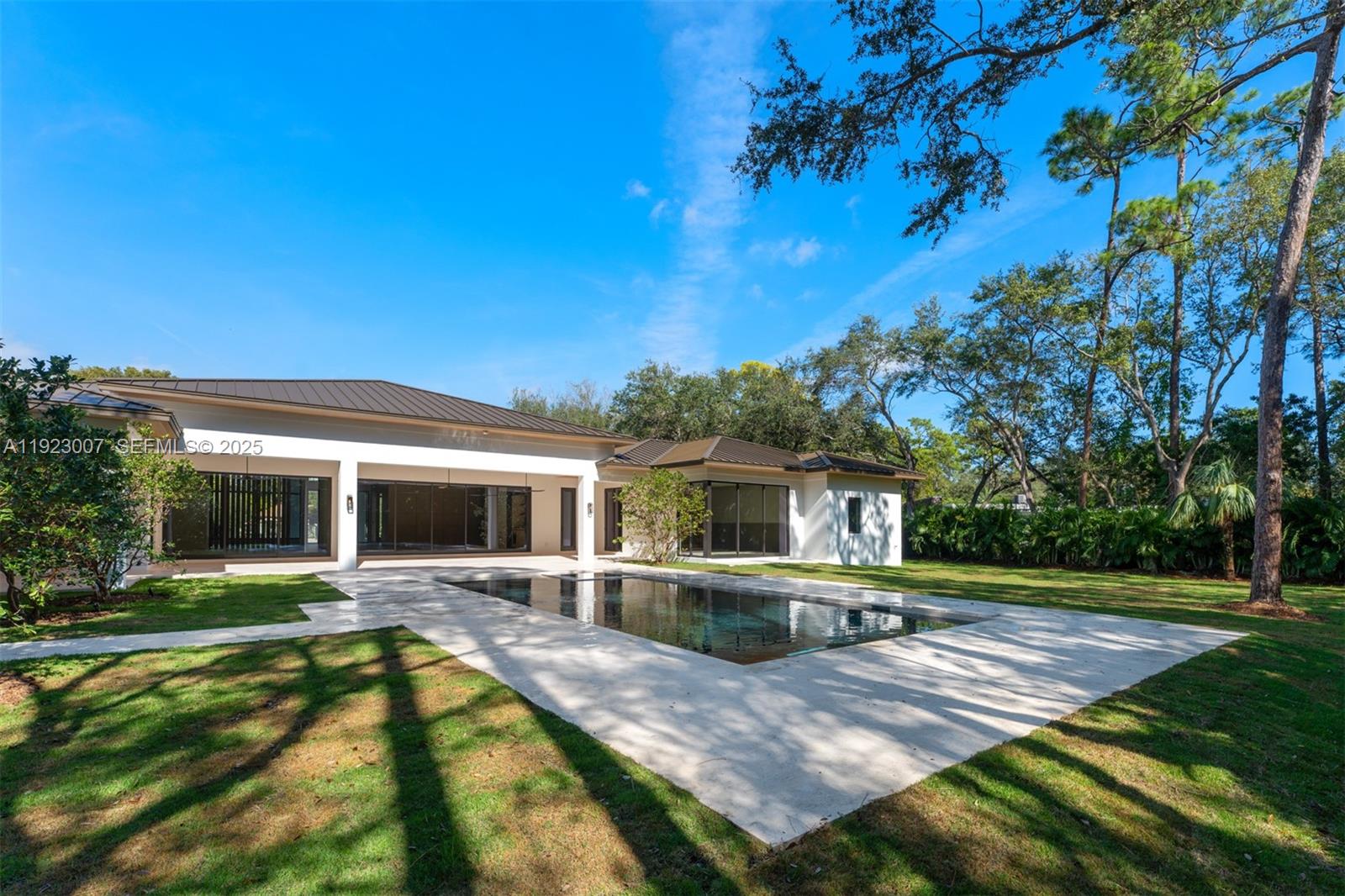 6840 Southwest 92nd Street Pinecrest, FL 33156 - Photo 40 of 42 a view of a house with swimming pool