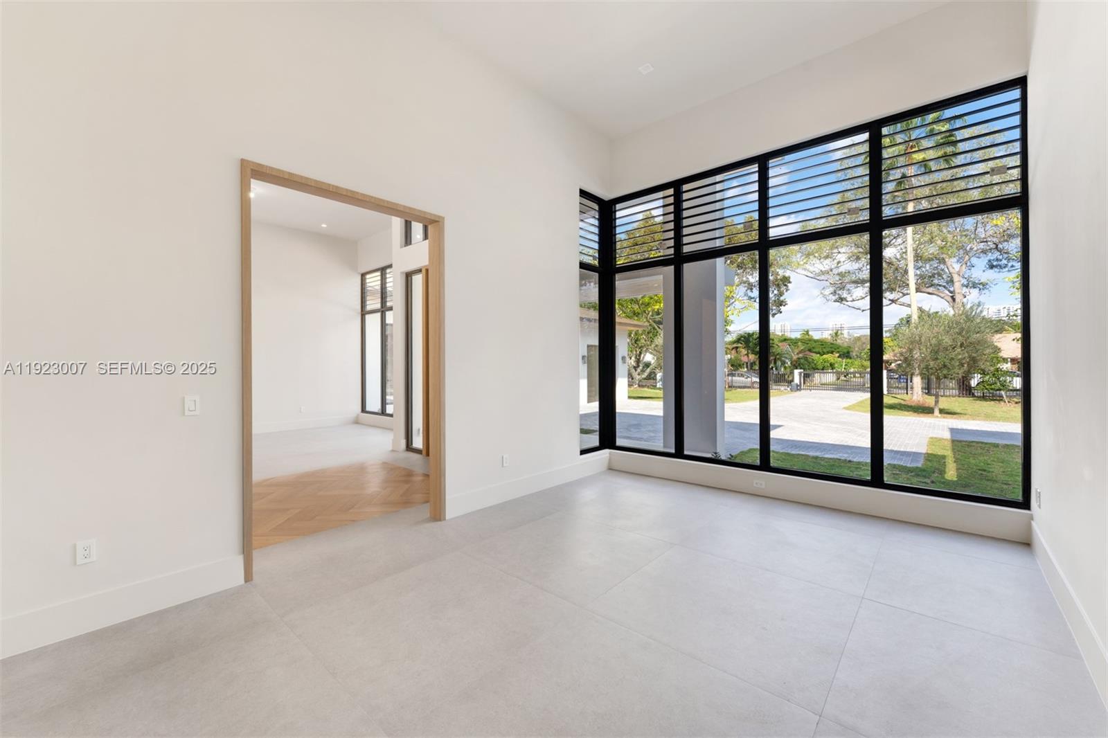 6840 Southwest 92nd Street Pinecrest, FL 33156 - Photo 5 of 42 wooden floor in an empty room with a window