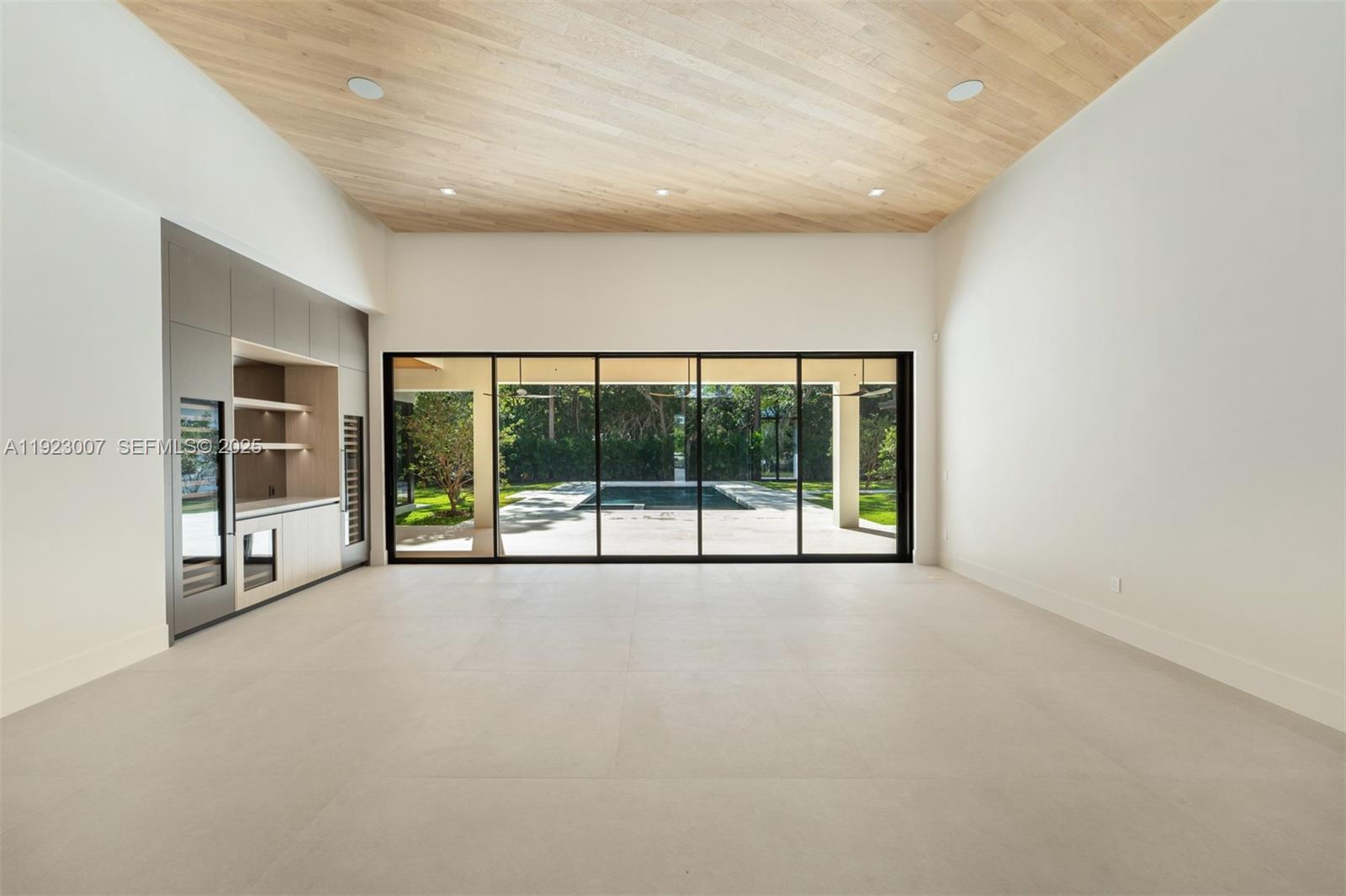 6840 Southwest 92nd Street Pinecrest, FL 33156 - Photo 6 of 42 a view of an empty room with a large window