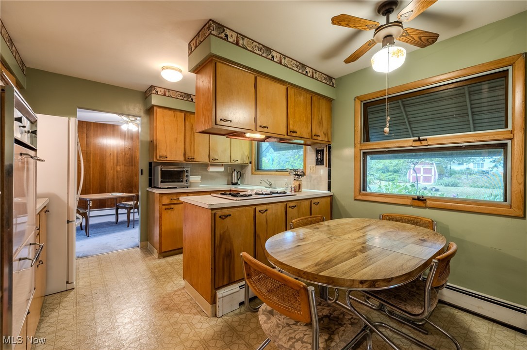 1950 Rush Road Wickliffe, OH 44092 - Photo 37 of 50 Kitchen with a ceiling fan, a peninsula, brown cabinets, light floors, and light countertops