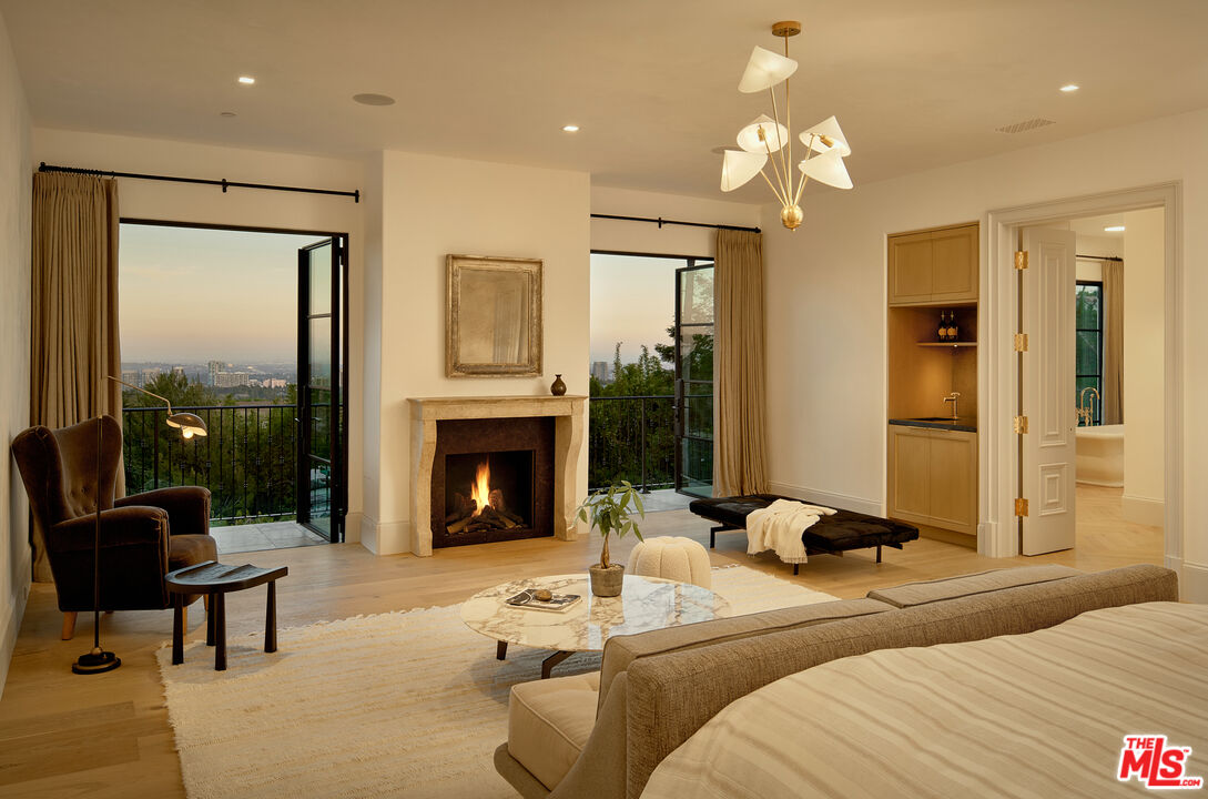 701 Nimes Road Los Angeles, CA 90077 - Photo 13 of 24 a bedroom with furniture and a fireplace