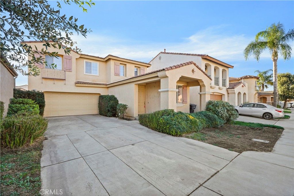 1465 Albillo Loop Perris, CA 92571 - Photo 1 of 1 a front view of a house with a yard and garage