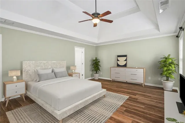 a bedroom with a large bed and a potted plant