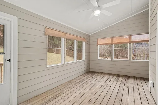 a view of a room with wooden floor and fan