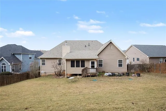 a view of a house with wooden fence