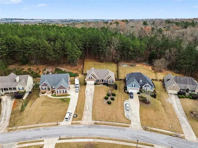 an aerial view of residential houses with outdoor space and swimming pool
