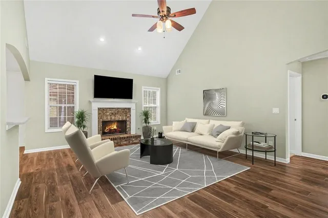 a living room with furniture a fireplace and a flat screen tv