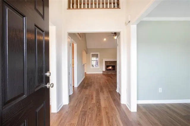 a view of a hallway view with wooden floor and staircase