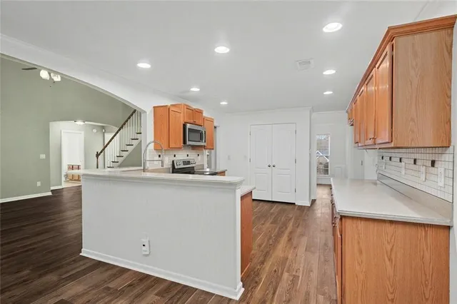 a kitchen with granite countertop a sink and a stove top oven