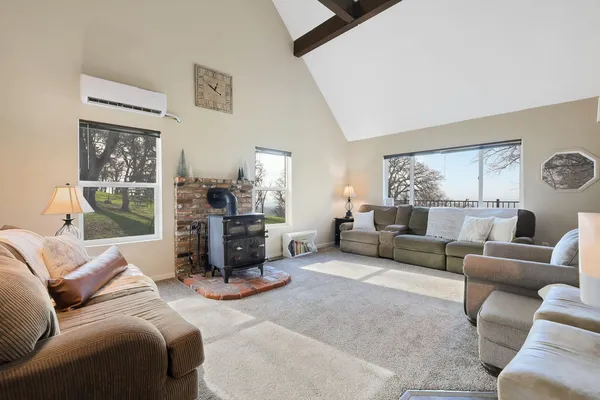 a kitchen with stainless steel appliances a microwave a stove a sink dishwasher and cabinets with wooden floor