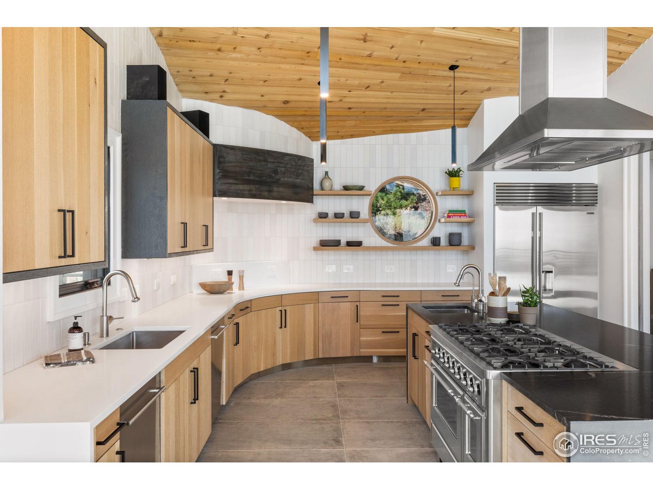 855 Timber Lane Boulder, CO 80304 - Photo 16 of 40 a kitchen with stainless steel appliances kitchen island granite countertop a sink and stove