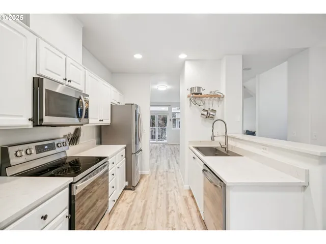 a kitchen with stainless steel appliances granite countertop a stove and a refrigerator