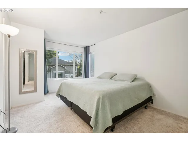 a bedroom with a large bed and a large window