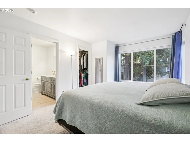 a bedroom with a bed and a night stand