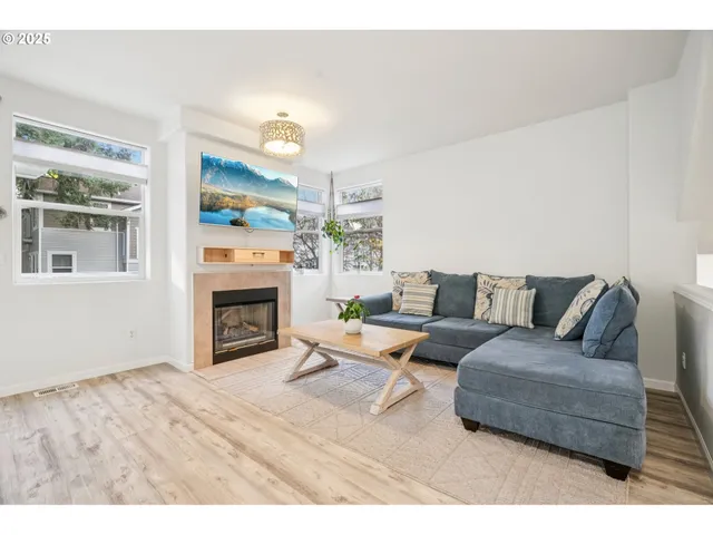 a living room with furniture and a fireplace