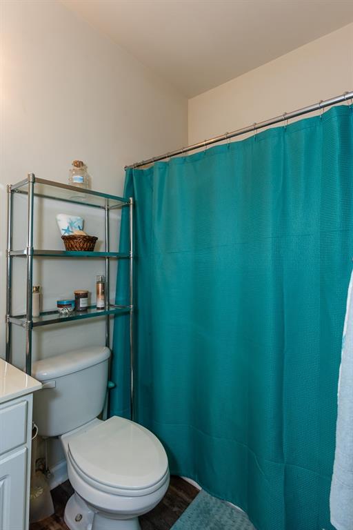 2799 Keystone Avenue Lithonia, GA 30058 - Photo 11 of 41 a bathroom with a toilet and a shower curtain