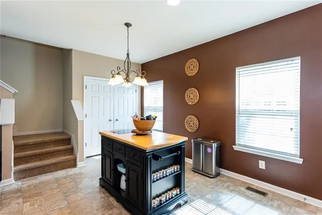a kitchen with stainless steel appliances granite countertop a stove a sink and a window