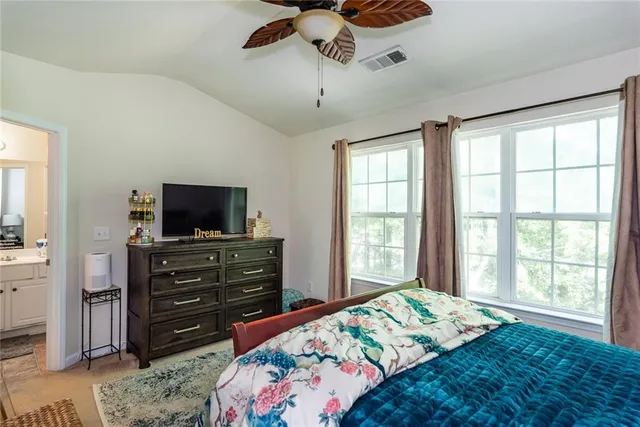 a bedroom with a bed and flat screen tv