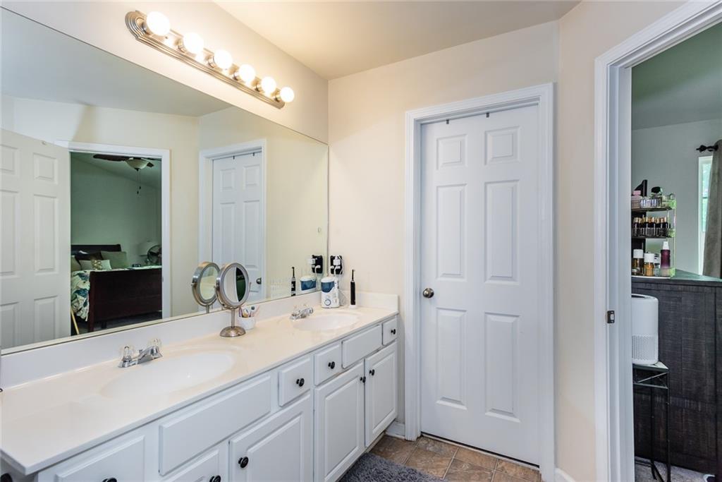 2799 Keystone Avenue Lithonia, GA 30058 - Photo 33 of 41 a bathroom with a double vanity sink and mirror