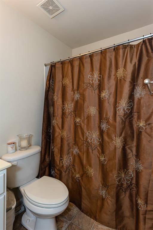 2799 Keystone Avenue Lithonia, GA 30058 - Photo 35 of 41 a white toilet sitting next to a shower curtain