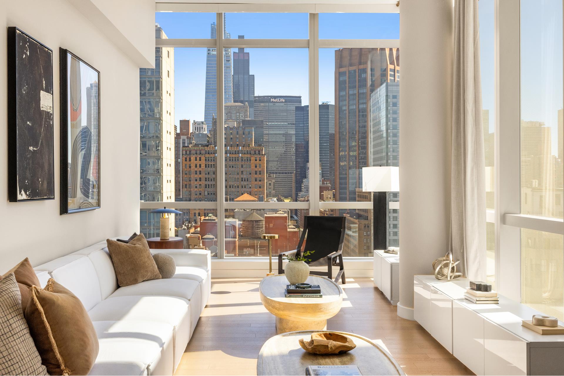 a living room with furniture and floor to ceiling windows