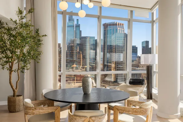 a dining room with furniture and wooden floor