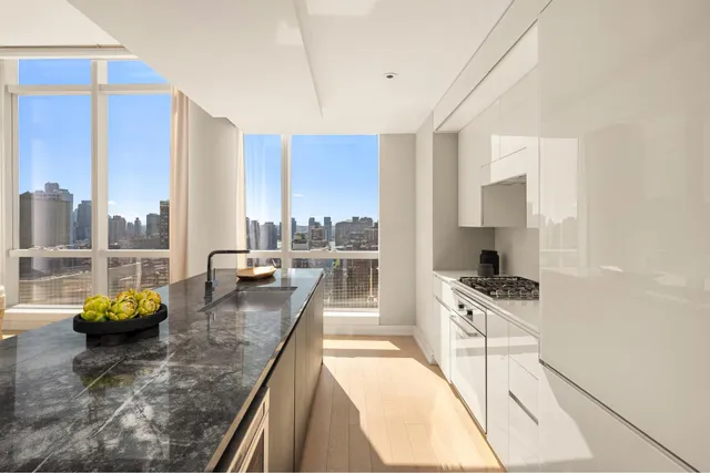 a kitchen with counter top space a stove and cabinets