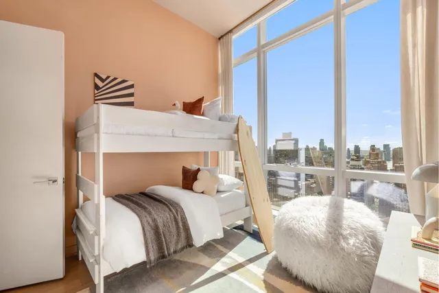 a bedroom with a large bed and a large window