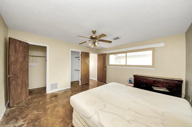 a view of a bedroom with a ceiling fan