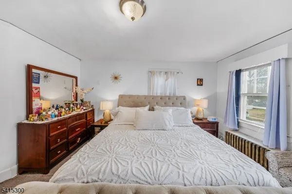a bedroom with a bed and a dresser in it