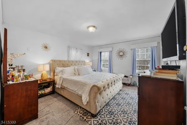 a bedroom with a bed and flat screen tv